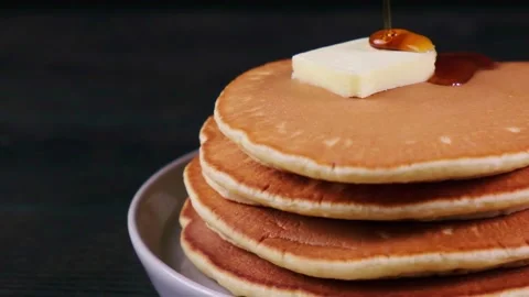Pancake stack with butter and maple syrup on dark background, close up. Stock Footage 151323665