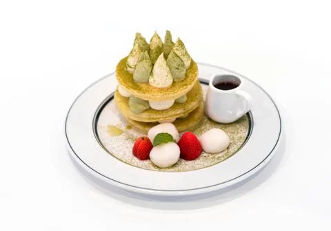 Pancake stack with green tea, syrup ,and strawberry isolated on white backgro Stock Photos