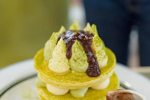 Pancake stack with green tea, syrup ,and strawberry isolated. Healthy breakfa Stock Photos