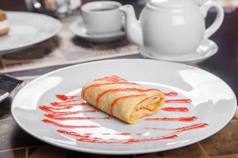 Pancake stuffed on a plate with jam Stock Photos