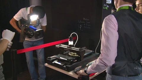 Pancakebot 3D printer bake ball shape pancake in Lithuania pavilion and people Stock Footage 78649204