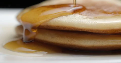 Pancakes and maple syrup macro slow motion 4K Stock Footage 148962474