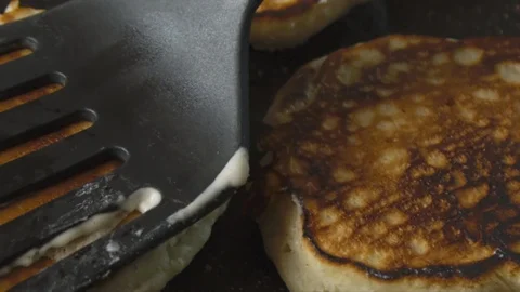 Pancakes being cooked and turned around with spatula Stock Footage 122183629