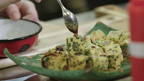 Pancakes being decorated with jam using a tea spoon Stock Footage 129016392