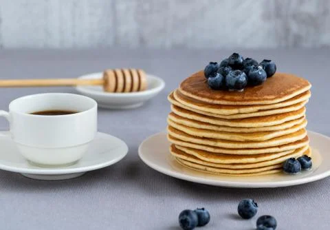 Pancakes with blueberries and honey of acacia. Stock Photos
