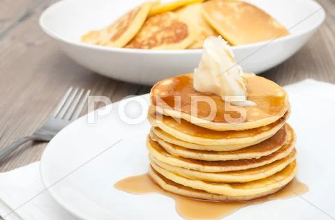 Pancakes with butter and maple syrup Stock Photos