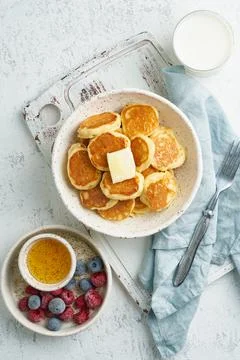 Pancakes cereal, tiny thin funny crumpet, children's food. Breakfast with drink Foto stock