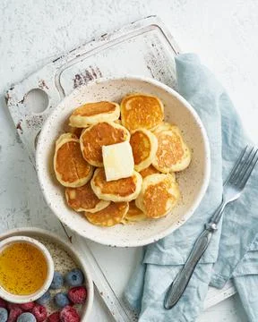 Pancakes cereal, tiny thin funny crumpet, children's food. Breakfast with drink Foto stock