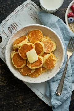 Pancakes cereal, tiny thin funny crumpet, children's food. Breakfast with drink Stock Photos