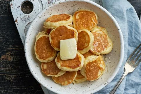 Pancakes cereal, tiny thin funny crumpet, children's food. Breakfast with drink Foto stock