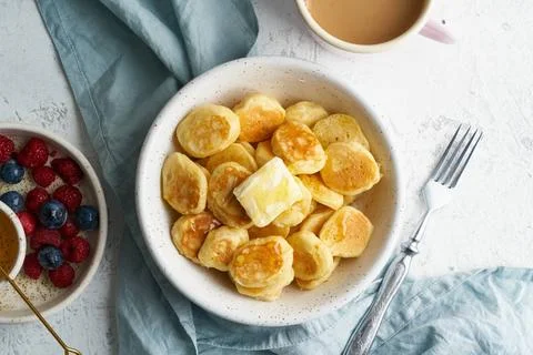 Pancakes cereal, tiny thin funny crumpet, children s food. Breakfast with ... Foto stock