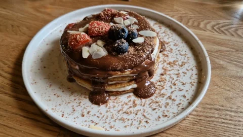 Pancakes with chocolate and berries close-up. Cafe, restaurant Stock Footage 242523564