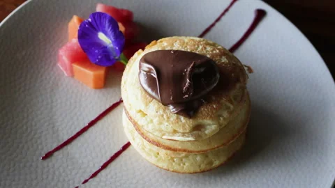 Pancakes with chocolate spread and fruit. Video stock 272911243