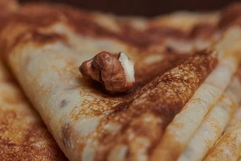 Pancakes close-up with nuts lying next to them Stock Photos