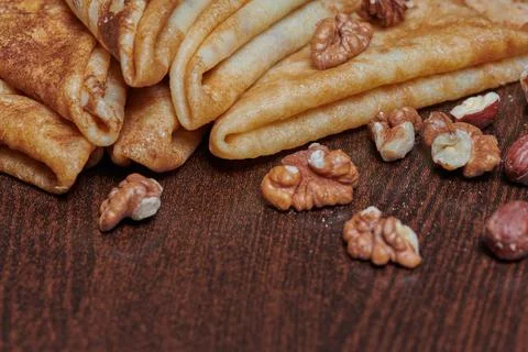 Pancakes close-up with nuts lying next to them Stock Photos