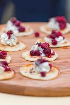 Pancakes cooked with a slice of ice cream and raspberries, served in small po Stock Photos