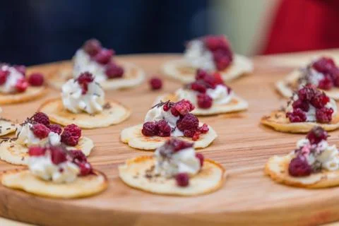 Pancakes cooked with a slice of ice cream and raspberries, served in small po Stock Photos