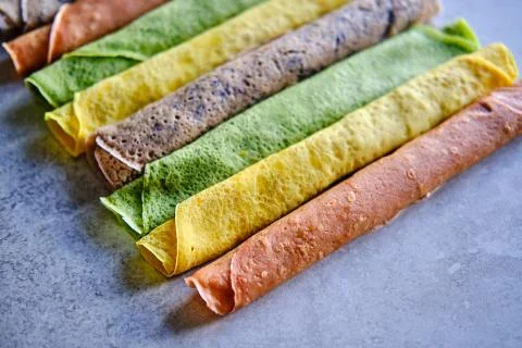 Pancakes of different color. Spinach, beetroot powder, blueberry and turmeric Stock Photos