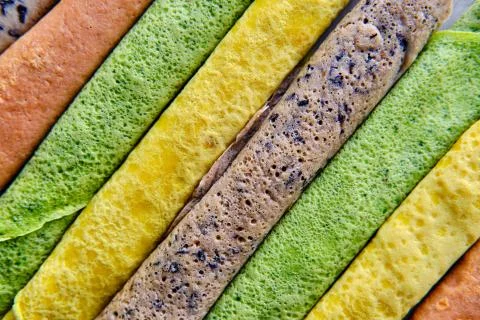 Pancakes of different color. Spinach, beetroot powder, blueberry and turmeric Stock Photos