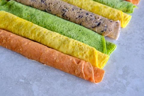 Pancakes of different color. Spinach, beetroot powder, blueberry and turmeric Stock Photos