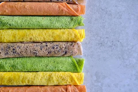 Pancakes of different color. Spinach, beetroot powder, blueberry and turmeric Stock Photos