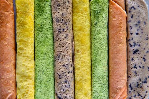 Pancakes of different color. Spinach, beetroot powder, blueberry and turmeric Stock Photos