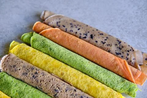 Pancakes of different color. Spinach, beetroot powder, blueberry and turmeric Stock Photos