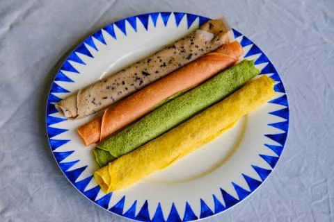 Pancakes of different color. Spinach, beetroot powder, blueberry and turmeric Stock Photos