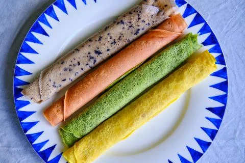 Pancakes of different color. Spinach, beetroot powder, blueberry and turmeric Stock Photos
