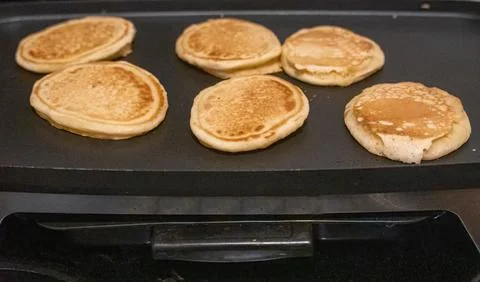 Pancakes on griddle 스톡 사진