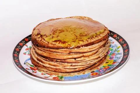 Pancakes with honey on a white background Stock Photos