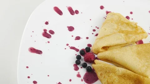 Pancakes with jam. Raspberry and blueberry berries. On a white plate. Stock Footage 127527229