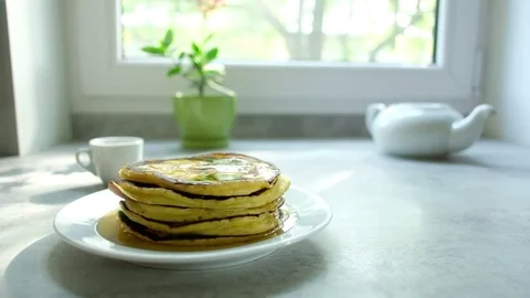 Pancakes on kitchen table Stock Footage 81778217