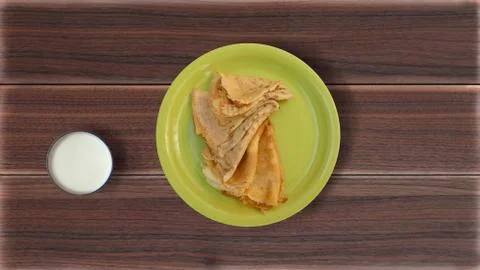 Pancakes in a plate on a table Stock Photos