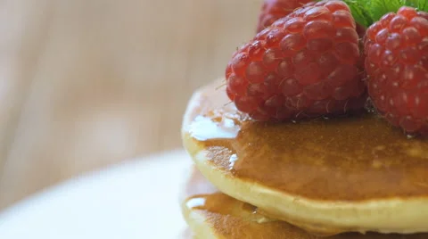 Pancakes with raspberry on wood background Stock Footage 64582623