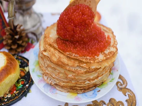 Pancakes with red caviar close-up on the background of the festive table Stock Footage 84918137