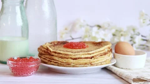 Pancakes with red caviar close-up on the background of the festive table Stock Footage 234446844
