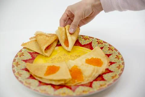 Pancakes with red caviar on a light background with beautiful bokeh Stock Photos