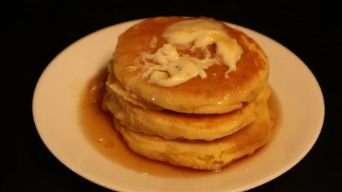 Pancakes Stack on Plate with Syrup Fork Taking Bite Stock Footage 127264844