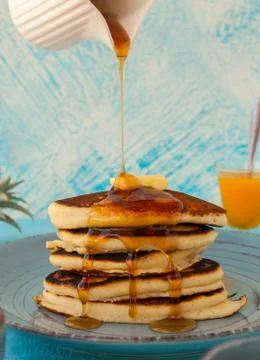 Pancakes stack pouring marple syrup. Little jug. Breakfast. Jem, Papaya. side Stock Photos