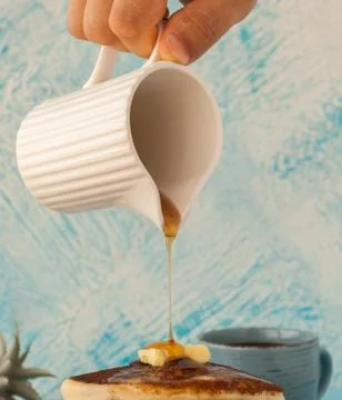 Pancakes stack pouring marple syrup. Little jug. Breakfast. coffee cup. side Stock Photos