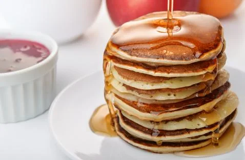 Pancakes stack pouring marple syrup Stock Photos