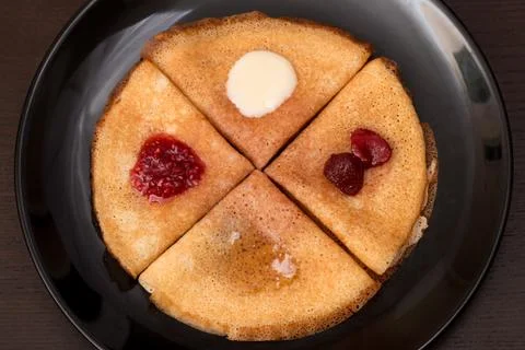 Pancakes with strawberry jam, raspberry jam , sour cream and honey Stock Photos