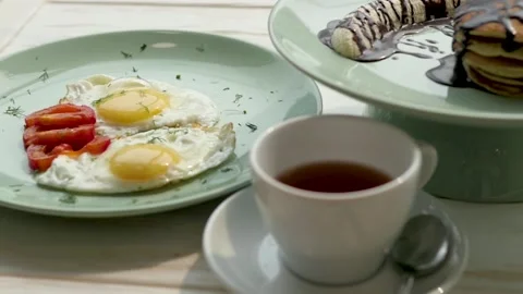 Pancakes with syrup, bacon scrambled eggs and coffee for breakfast. complex Stock-Footage 139729392