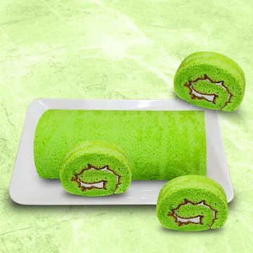 Pandan rolled sponge cake on a white plate 스톡 사진