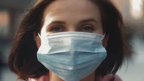 Pandemic in china, portrait of a young tourist woman wearing protective mask on Stock Footage