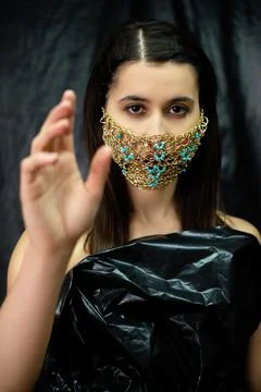 Pandemic fashion woman luxury gold chain face mask Stock Photos