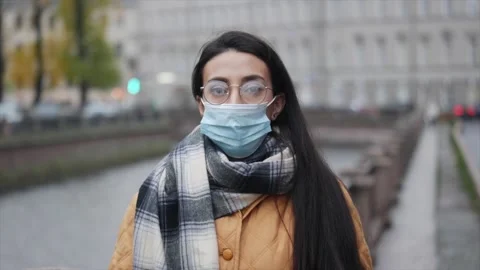 Pandemic, portrait of a young middle eastern woman wearing protective mask on Stock Footage 142874928