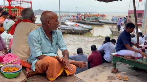 Pandit looking around, waiting for devotees at Varanasi Ghat Stock Footage 285024527