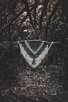 Panel of blue and white macrame on a decorative branch in nature Stock Photos